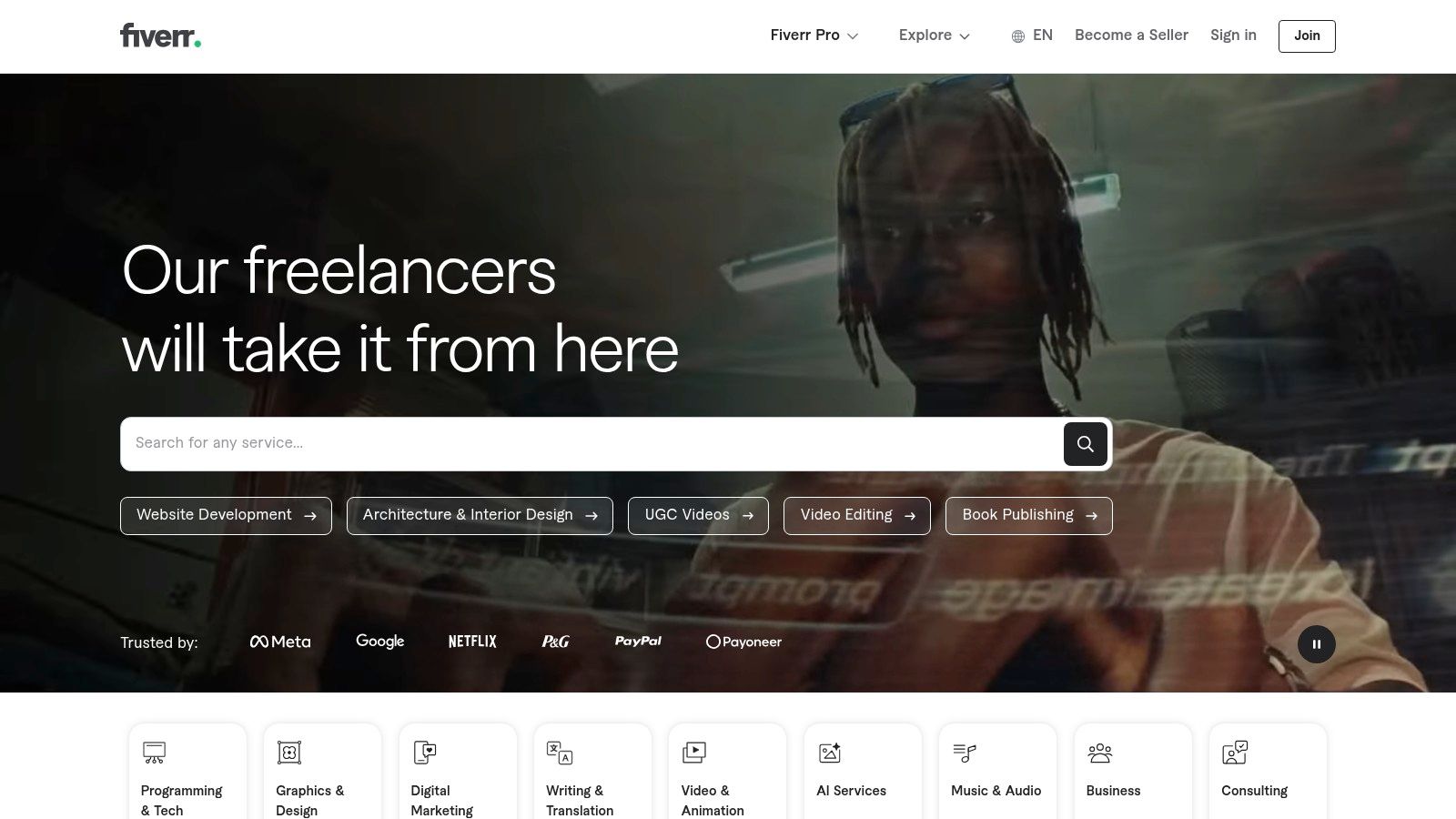 A screenshot of the Fiverr homepage showcasing the search bar and categories for finding freelance services.